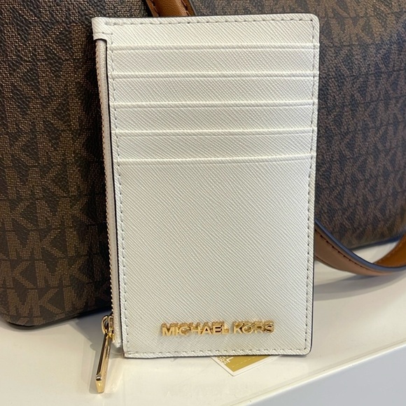 Michael Kors Handbags - MICHAEL KORS
Jet Set Travel Medium Top Zip Leather Card Case Wallet 
Optic White